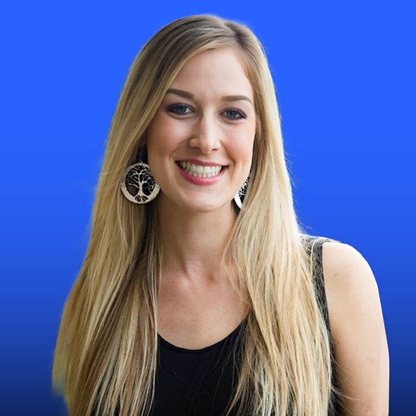 Portrait of Erin Langlais on a vibrant blue background.