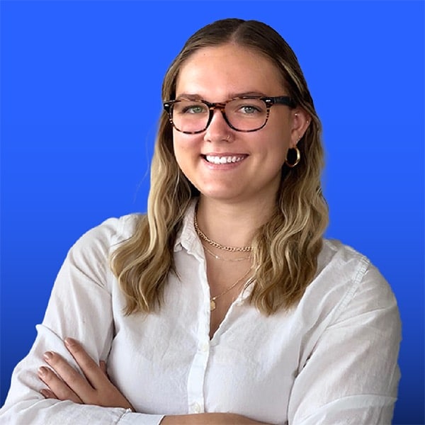 Portrait of Katie Rick on a vibrant blue background.